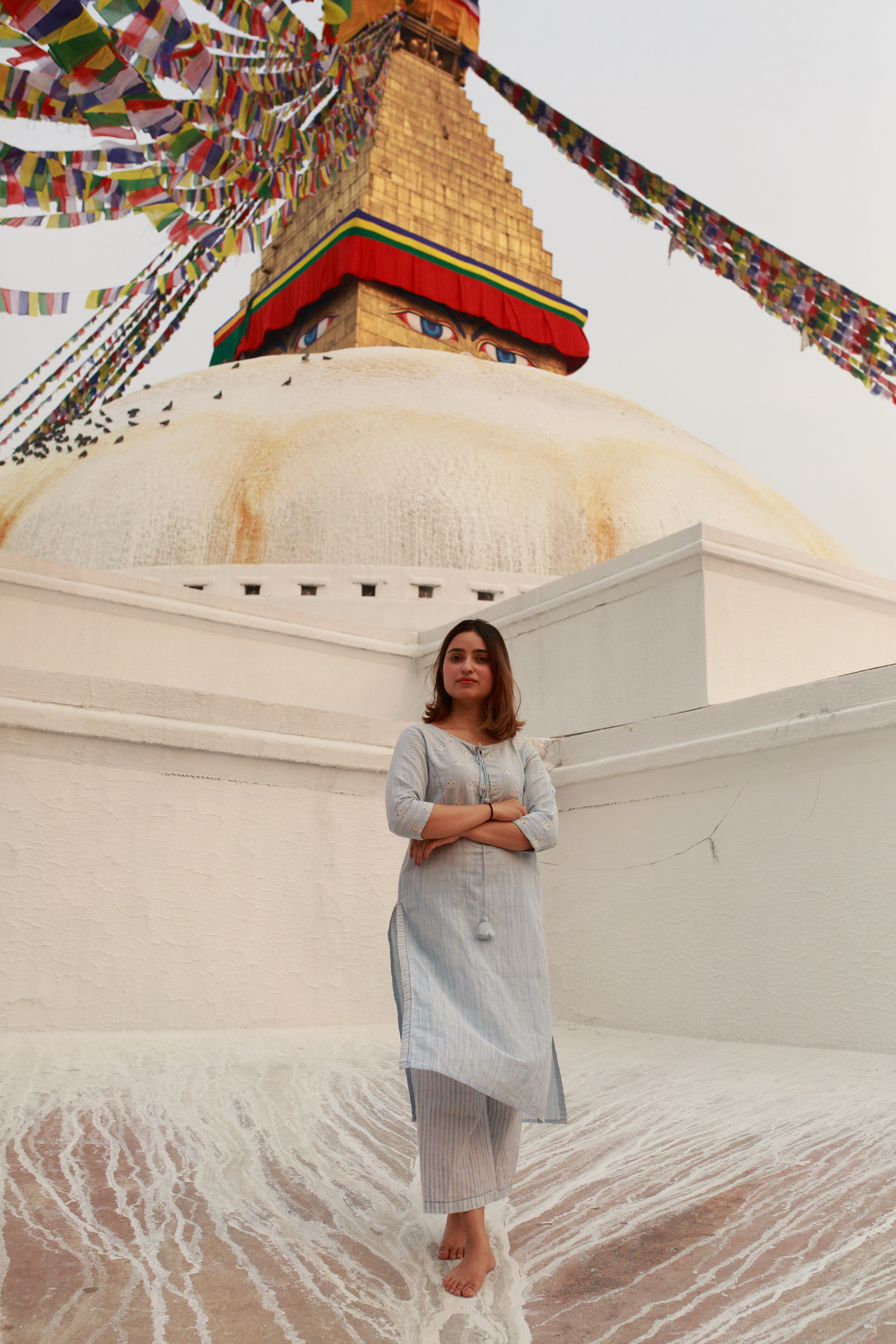 Woman standing before a stupa in Nepal
